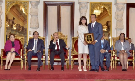  imagen De derecha a izquierda sentados, ministros Alejandrina Germ&aacute;n, Gustavo Montalvo y Presidente Danilo Medina. De pie a la derecha Ministro Antonio Pe&ntilde;a Mirabal entrega reconocimiento a&nbsp;Mar&iacute;a Marinick. 