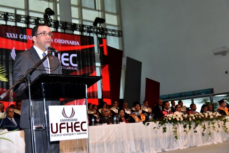  imagen Ministro Andr&eacute;s Navarro de pie en podium dirigiendo discurso a cientos de profesionaes en&nbsp;XXXI Graduaci&oacute;n Ordinaria de la Universidad Federico Henr&iacute;quez y Carvajal (UFHEC). 
